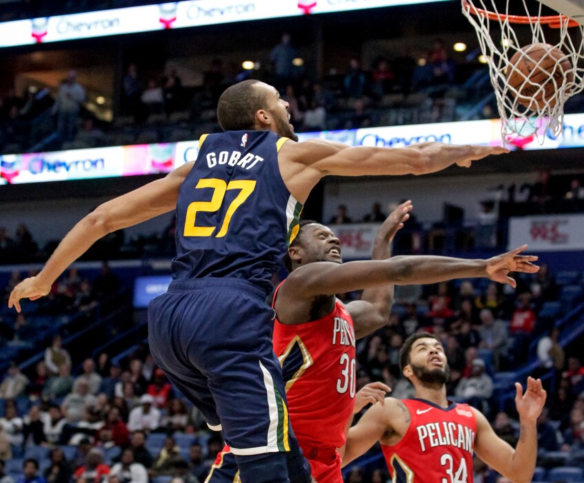 Utah Jazz center Rudy Gobert (27) dunks over New Orleans Pelicans center Julius Randle (30) during the second half of an NBA basketball game in New Orleans, Wednesday, March 6, 2019. The Jazz won 114-104. (AP Photo/Scott Threlkeld)