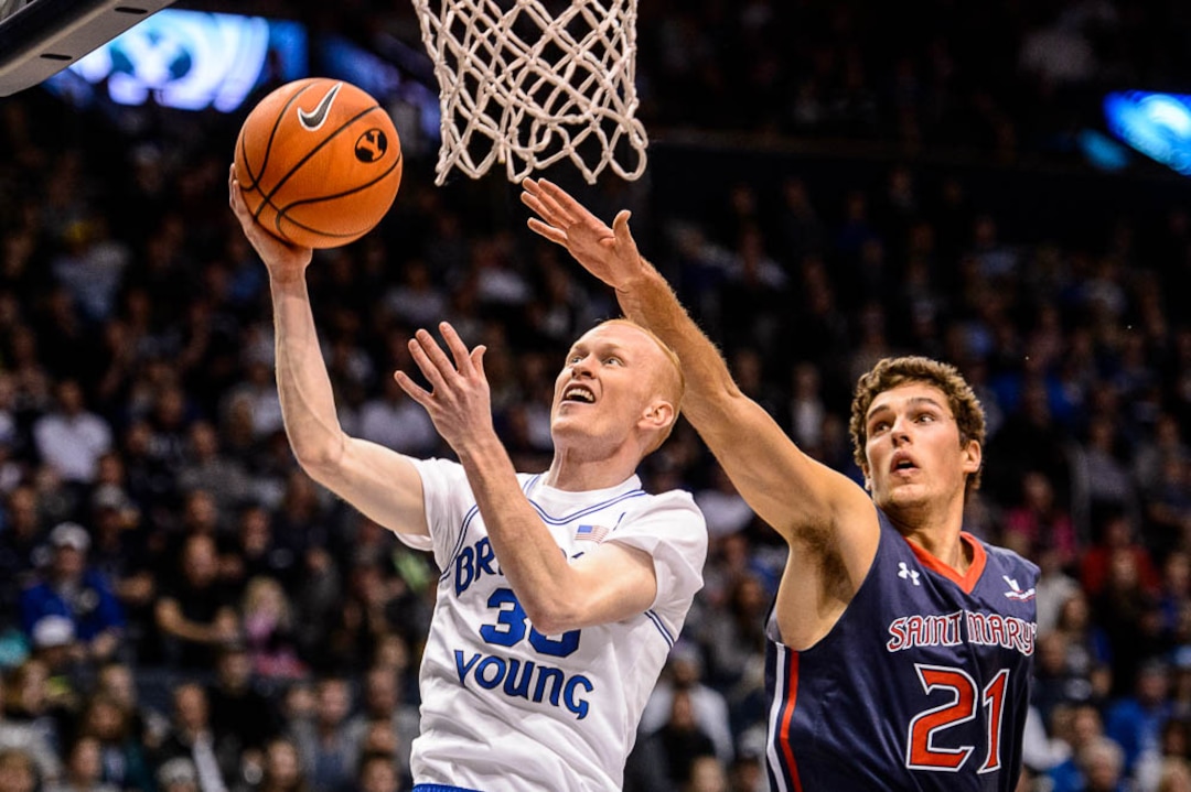 (Trent Nelson | The Salt Lake Tribune)   Brigham Young Cougars guard TJ Haws (30) drives past St. Mary's Gaels center Evan Fitzner (21) as BYU hosts the St. Mary's Gaels, NCAA basketball in Provo, Saturday December 30, 2017.