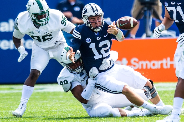 (Chris Detrick  |  The Salt Lake Tribune)  Portland State Vikings defensive end Davond Dade (99) sacks Brigham Young Cougars quarterback Tanner Mangum (12) during the game at LaVell Edwards Stadium Saturday, August 26, 2017.
