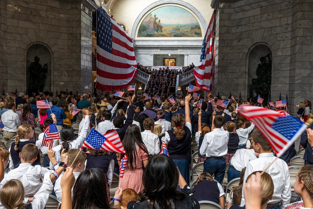 (Rick Egan | The Salt Lake Tribune) Guests wave flags during the the Constitution Month Kick Off News Conference at the Capitol, on Thursday, Aug. 31, 2023.