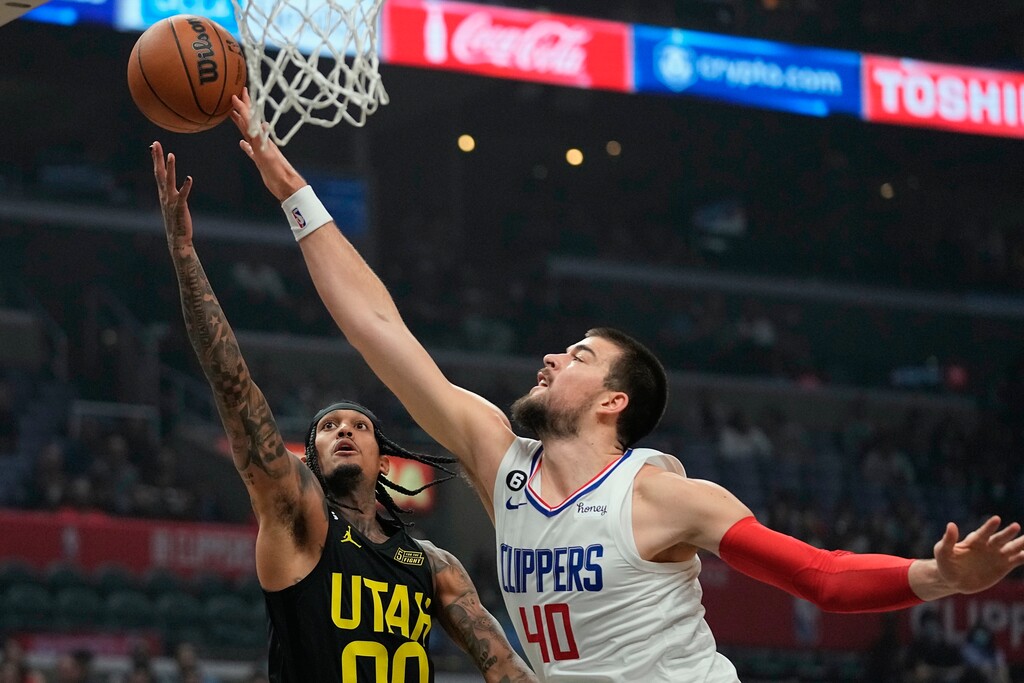 Utah Jazz guard Jordan Clarkson, left, shoots as Los Angeles Clippers center Ivica Zubac defends during the first half of an NBA basketball play-in tournament game Sunday, Nov. 6, 2022, in Los Angeles. (AP Photo/Mark J. Terrill)