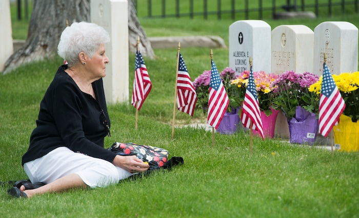 (Rick Egan  |  The Salt Lake Tribune)      
Karen Keck, sit by the graves of her father, sister and brothers at the Fort Douglas Cemetery, after the Memorial Day observance Monday, May 28, 2018.


