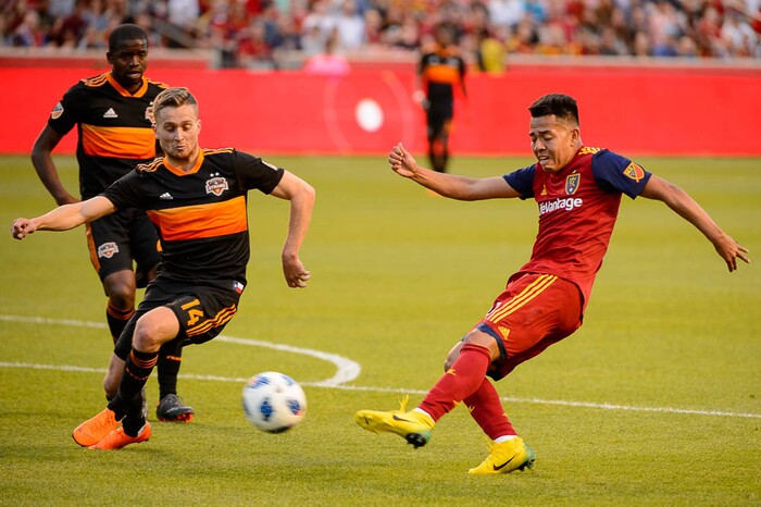 (Trent Nelson | The Salt Lake Tribune)  
Real Salt Lake midfielder Sebastian Saucedo (23) takes a shot with Houston Dynamo midfielder Charlie Ward (14) defending as Real Salt Lake hosts Houston Dynamo, MLS Soccer at Rio Tinto Stadium in Sandy, Utah, Wednesday May 30, 2018.