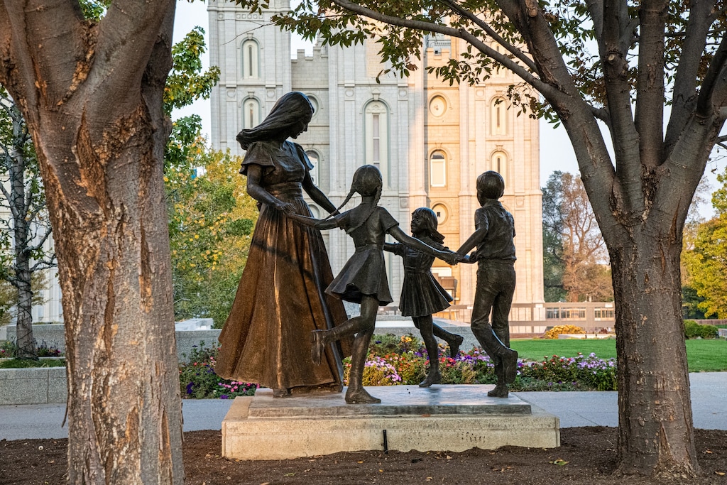 (The Church of Jesus Christ of Latter-day Saints) Statue on Salt Lake City's Temple Square, before its makeover, depicts a mother playing with her children.
