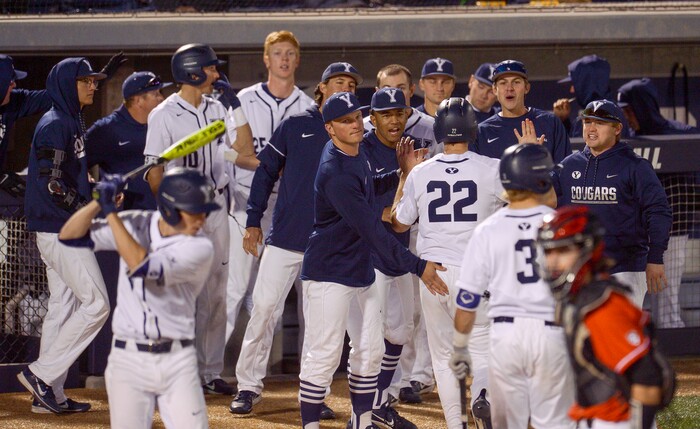 (Leah Hogsten  |  The Salt Lake Tribune) BYU's David Clawson is congratulated on his scoring run in the 7th inning  as Brigham Young University hosts University of Utah at Miller Park, Tuesday, April 24, 2018 in Provo.
