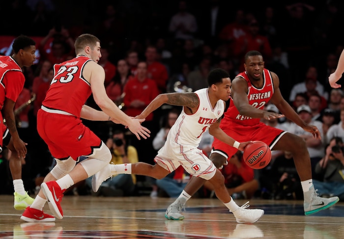 Utah guard Justin Bibbins (1) runs the clock down as he dribbles through the Western Kentucky defense during the second half of an NCAA college basketball game during the semifinals of the NIT, Tuesday, March 27, 2018, in New York. Utah won 69-64. (AP Photo/Julie Jacobson)