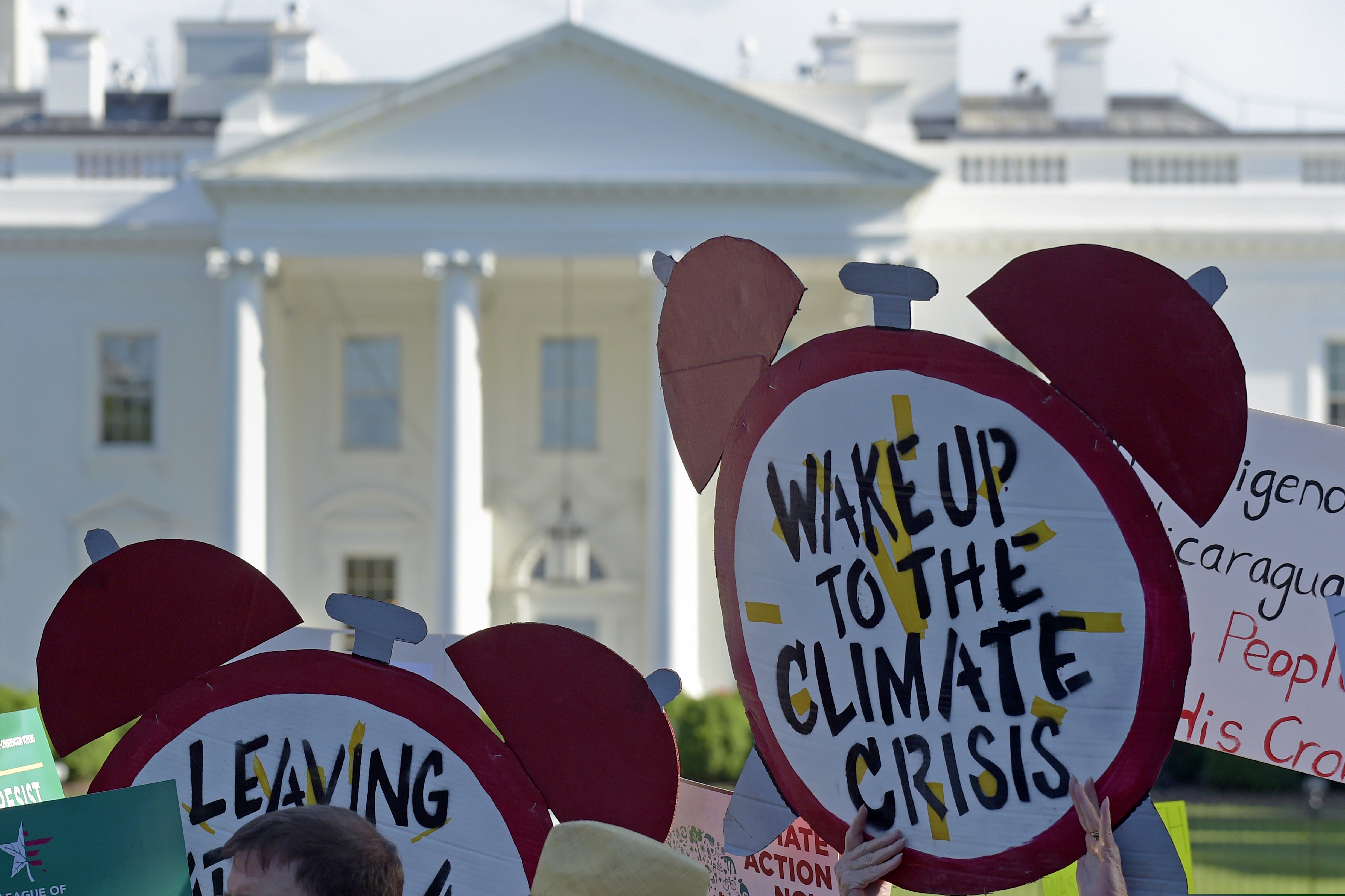 (Susan Walsh | AP file photo) In this June 1, 2017, photo, protesters gather outside the White House in Washington to protest President Donald Trump's decision to withdraw the Unites States from the Paris climate change accord.