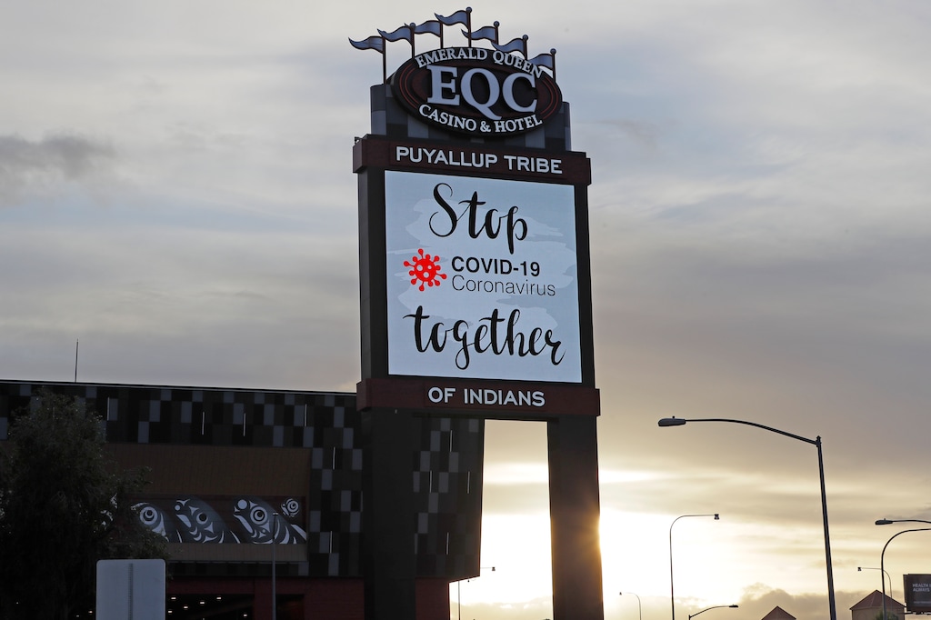 (Ted S. Warren | The Associated Press) In this April 30, 2020, photo, a sign reads "Stop COVID-19 Coronavirus together" at the new Emerald Queen Casino in Tacoma, Wash.. The casino is owned by the Puyallup Tribe of Indians and is currently closed. Hundreds of tribal casinos across the country have voluntarily closed because of the coronavirus pandemic, in many cases taking away a tribe's primary source of revenue used to operate tribal government and social programs.