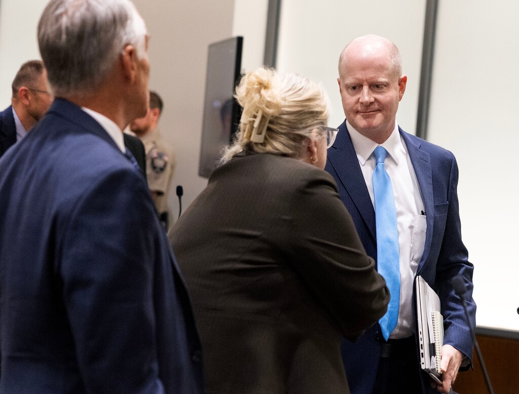 (Laura Seitz | Pool) Utah County prosecutor Chad Grunander, right, meets defense attorney Kathryn Nester, following a waiver hearing for Tyler James Robinson, the man accused of killing Charlie Kirk at Utah Valley University, in Fourth District Court in Provo, on Monday, Sept. 29, 2025.