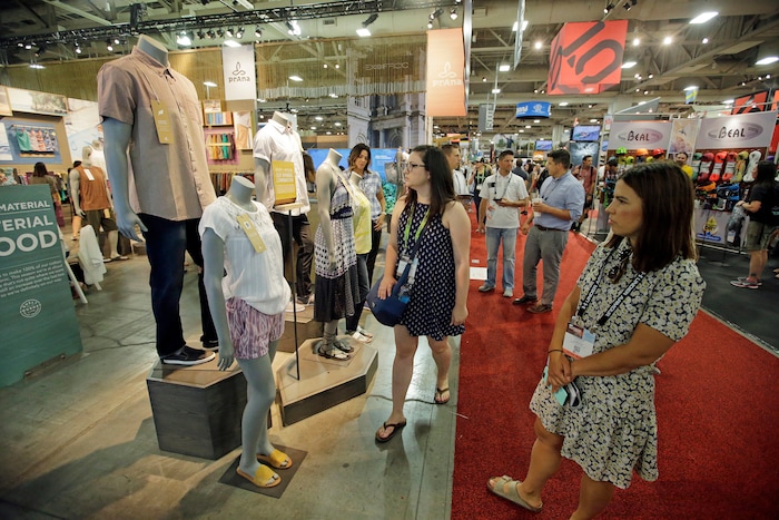 People walk pass the Prana exhibit during the Outdoor Retailer show Thursday, Aug. 4, 2016, in Salt Lake City. A wide array of clothing, gear and equipment specifically designed for women outdoor adventurers is on display at the summer version of the world's largest outdoor gear show for retailers that brings thousands of people to Salt Lake City. (AP Photo/Rick Bowmer)