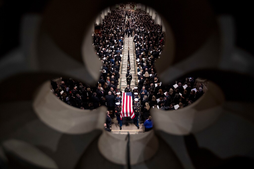 (AP Photo/Andrew Harnik, Pool) The flag-draped casket of former President George H.W. Bush is carried out by a military honor guard during a State Funeral at the National Cathedral, Wednesday, Dec. 5, 2018, in Washington.