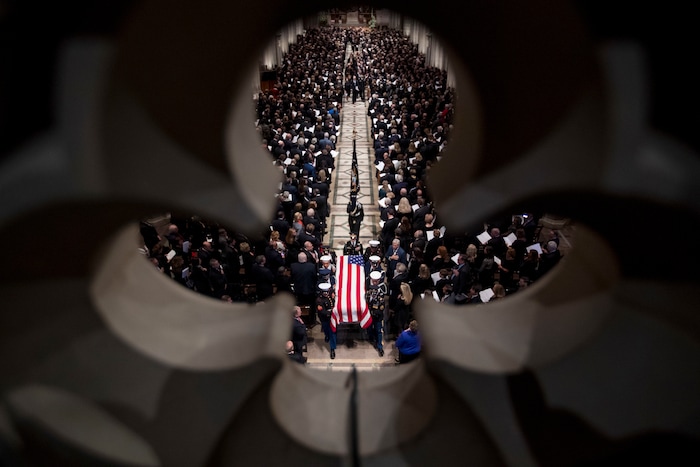 The flag-draped casket of former President George H.W. Bush is carried out by a military honor guard during a State Funeral at the National Cathedral, Wednesday, Dec. 5, 2018, in Washington. (AP Photo/Andrew Harnik, Pool)