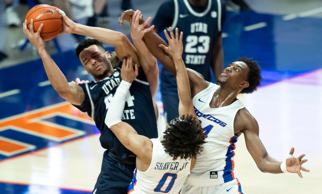 Boise State guard Marcus Shaver, Jr. and teammate Abu Kigab pressure Utah State guard Marco Anthony during the second half of an NCAA college basketball game Wednesday, Feb. 17, 2021 at ExtraMile Arena in Boise, Idaho. (Darin Oswald/Idaho Statesman via AP)
