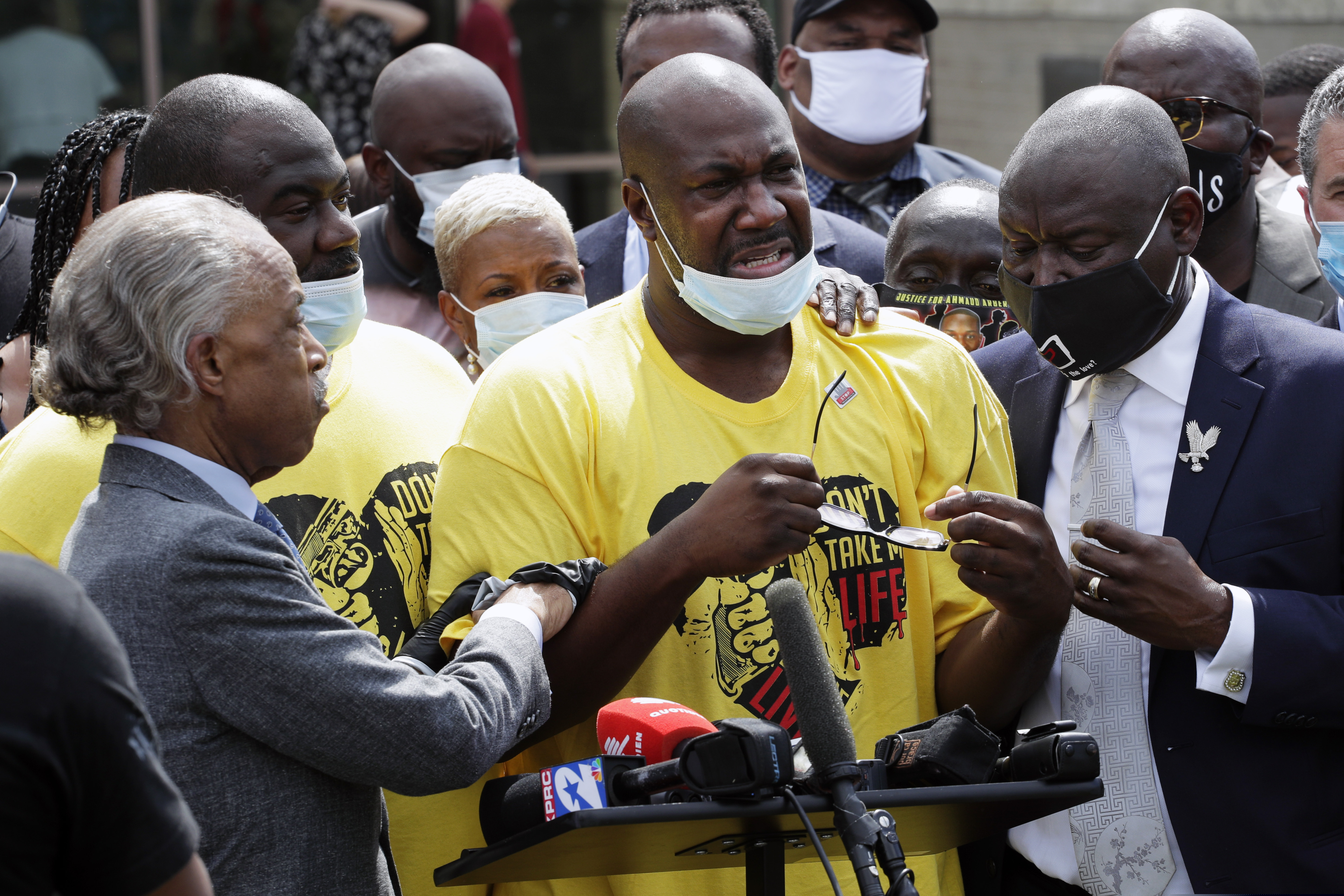(Eric Gay | AP)  Philonise Floyd, center is comforted by the Rev. Al Sharpton, left, and attorney Benjamin Crump, right at a news conference during a public visitation for his brother George Floyd at The Fountain of Praise church in Houston, Monday, June 8, 2020, in Houston.