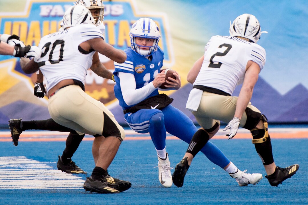 (Jeremy Harmon  |  The Salt Lake Tribune) Brigham Young Cougars quarterback Zach Wilson (11) runs the ball as BYU faces the Western Michigan Broncos in the Famous Idaho Potato Bowl in Boise, Idaho, on Friday, Dec. 21, 2018.