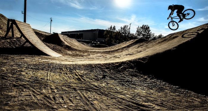 (Steve Griffin  |  The Salt Lake Tribune)  Riders leap through the air as they enjoy a newly constructed  BMX bike park on 900 south near 700 west in Salt Lake City Monday October 30, 2017. 