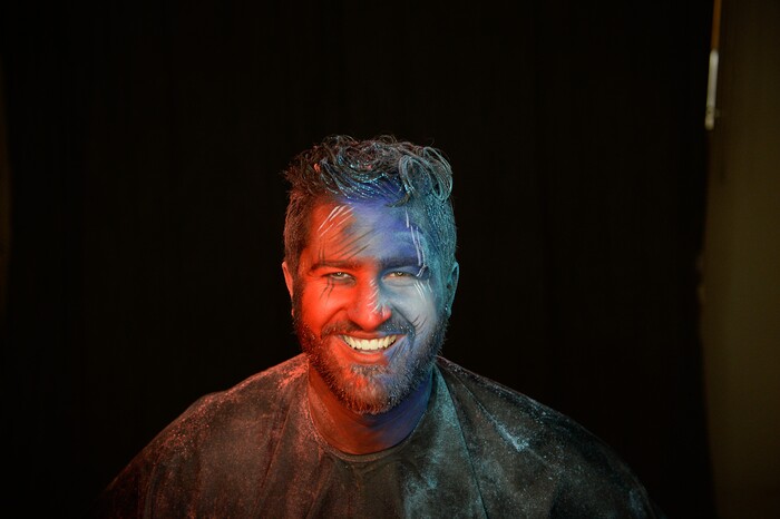 (Francisco Kjolseth | The Salt Lake Tribune) BYU and Utah fan alike Brad Klekas of South Jordan shows his mutual admiration by stepping into the Tribune studio to get both colors in anticipation of the upcoming match up between the two rival teams on Saturday.