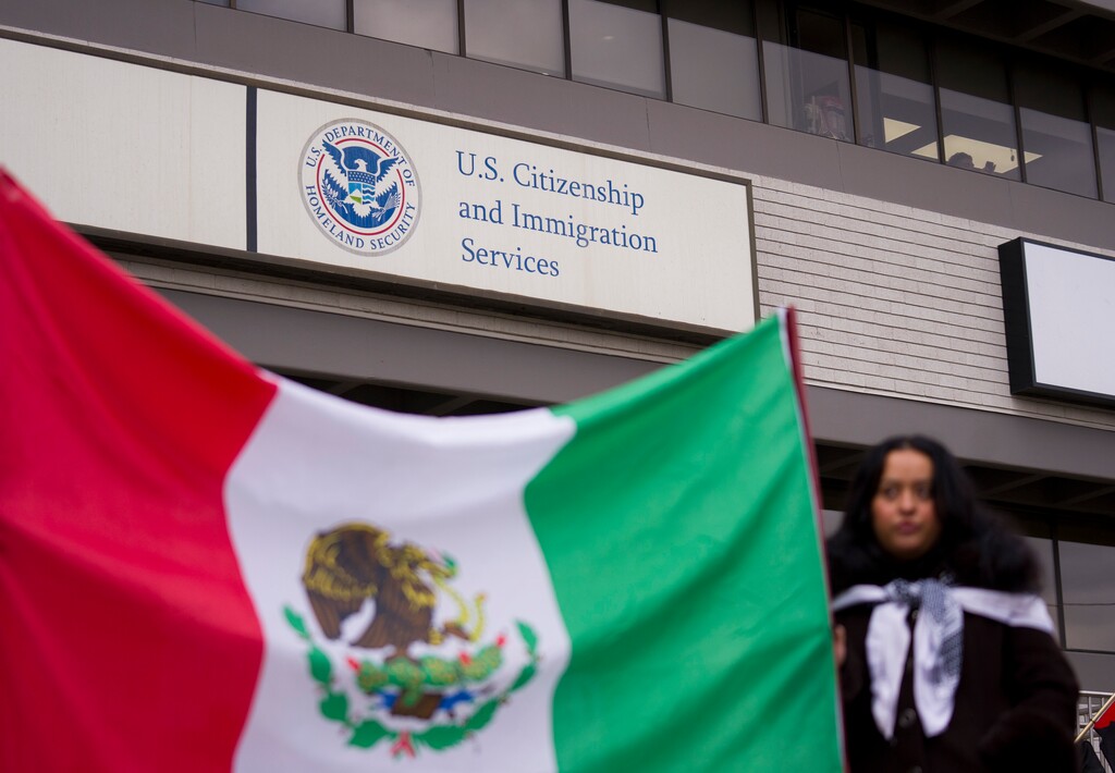 (Bethany Baker | The Salt Lake Tribune) Protesters gather outside the U.S. Citizenship and Immigration Services building in Salt Lake City on Monday, Dec. 8, 2025.