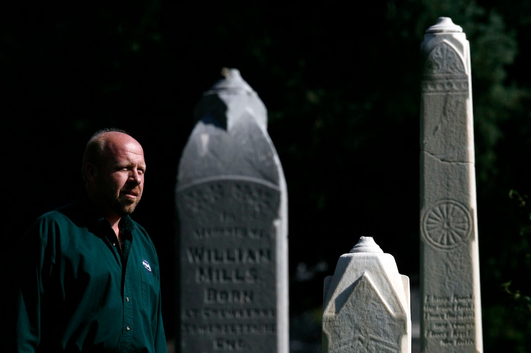 (Francisco Kjolseth  |  Tribune file photo) Mark Smith stands among grave markers at the Salt Lake City Cemetery in this 2005 file photo. For 20 years, Smith was the sexton of the Salt Lake City Cemetery and wrote a book about the burial grounds. Smith died July 30, 2019, from multiple myeloma at age 55.