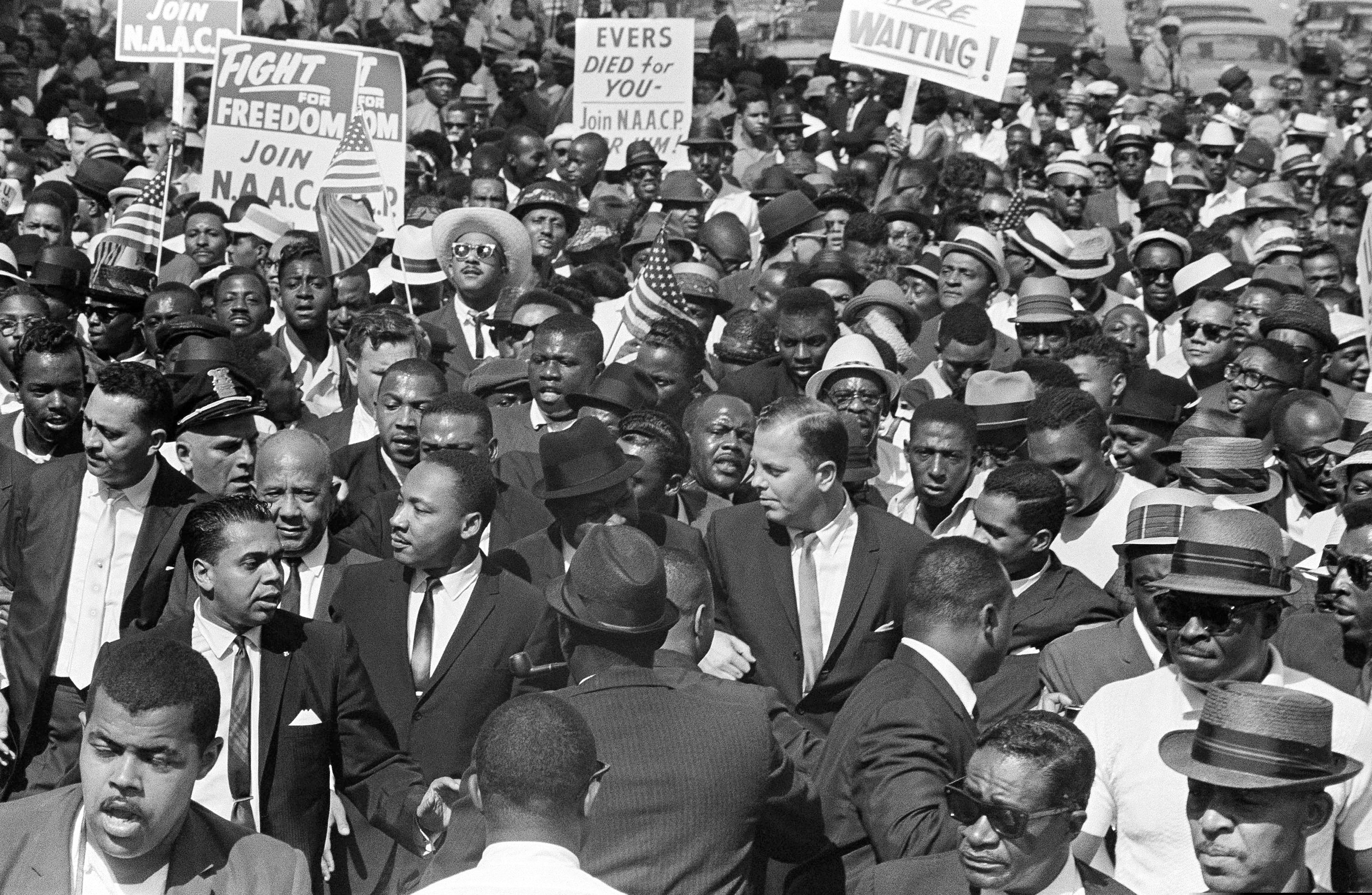 (AP Photo/File)

In this June 23, 1963, photo, the Rev. Martin Luther King joins Detroit's Freedom March.