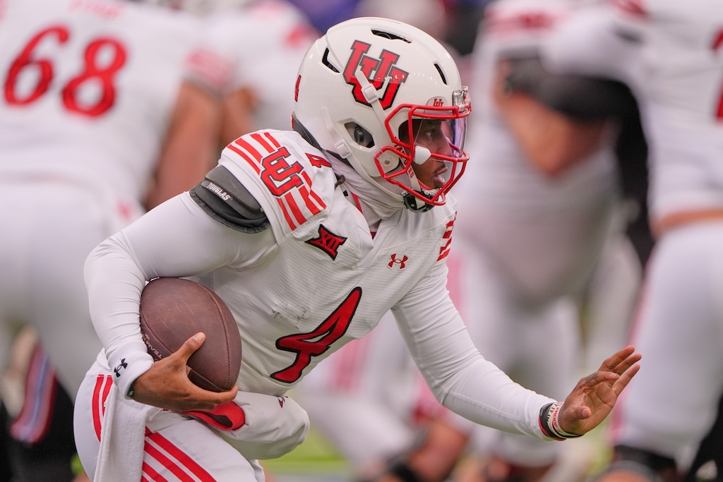 (Charlie Riedel | AP) Utah quarterback Devon Dampier runs the ball during the first half of an NCAA college football game against Kansas, Friday, Nov. 28, 2025, in Lawrence, Kan.