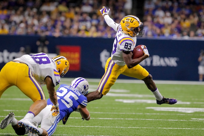 LSU wide receiver Russell Gage (83) slips away from BYU defensive back Tanner Jacobson (25) in the second half of an NCAA college football game in New Orleans, Saturday, Sept. 2, 2017. (AP Photo/Scott Threlkeld)