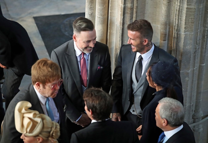 David and Victoria Beckham talk with Sir Elton John, left, and David Furnish as they arrive for the wedding ceremony of Prince Harry and Meghan Markle at St. George's Chapel in Windsor Castle in Windsor, near London, England, Saturday, May 19, 2018. (Danny Lawson/pool photo via AP)