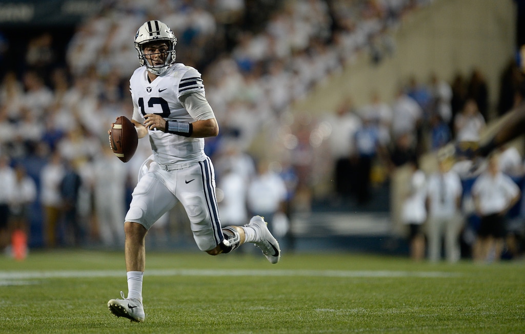 (Francisco Kjolseth  |  The Salt Lake Tribune)  Brigham Young Cougars quarterback Tanner Mangum (12) looks for an opening against California during the first half of the NCAA college football game, Saturday, Sept. 8, 2018, at LaVell Edwards stadium in Provo, Utah.