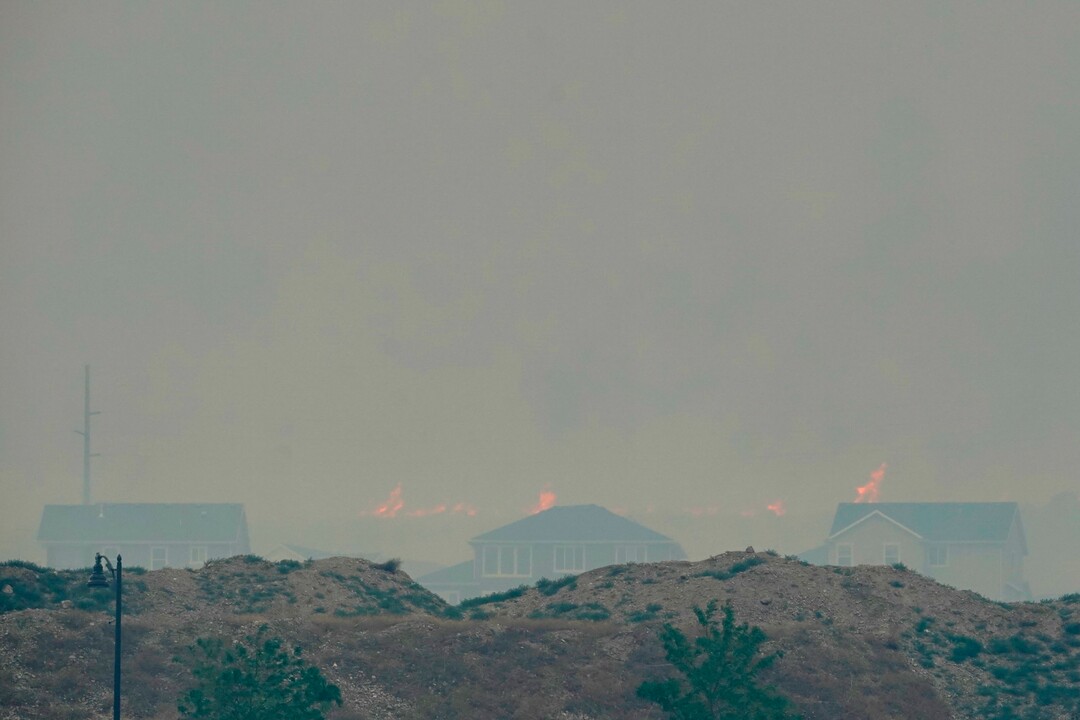 (George Frey  |  for The Salt Lake Tribune) Flames from a wildfire rise above homes in south Saratoga Springs on June 28, 2020.