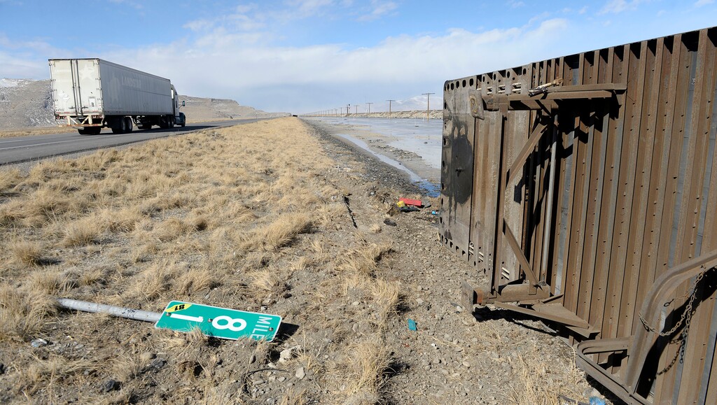 (Al Hartmann | The Salt Lake Tribune)
One of three semi truck trailers that flipped over on I-80 westbound in high winds around 8:00 a.m. Friday, March 2, 2018. The incidents happened between mile posts 79 to 82 just east of the Rowley-Dugway exit in Tooele County. Wrecking crews were kept busy all morning righting the rigs.