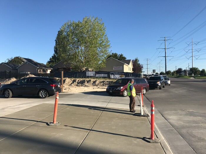 (Benjamin Wood | The Salt Lake Tribune)   Faculty members with American Preparatory Academy in Draper helped direct traffic as families arrived Monday for the first day of the 2017-2018 school year.