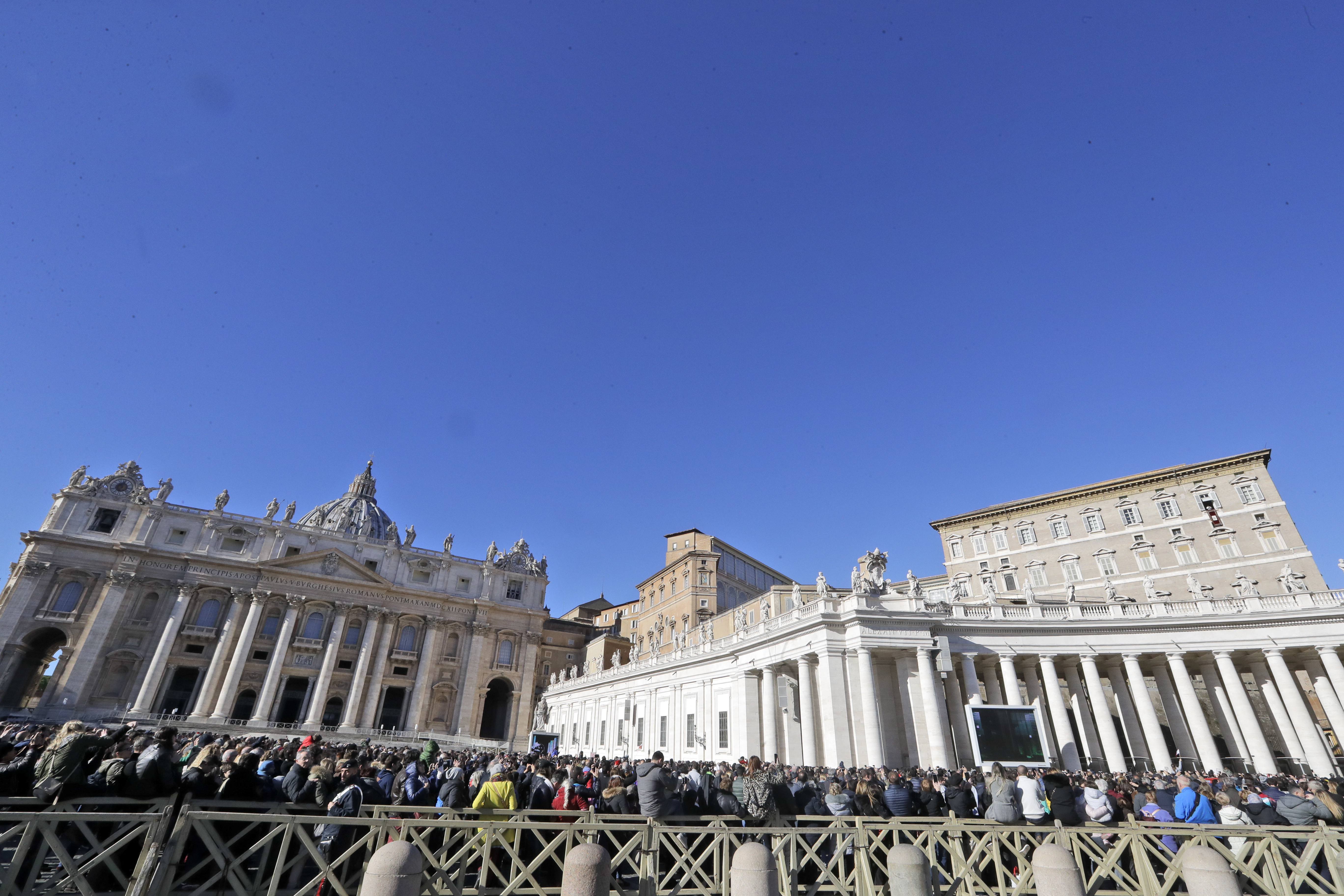 (AP Photo/Andrew Medichini) People gather in St. Peter's Square to attend a blessing by Pope Francis during the Angelus noon prayer he recited from the window of his studio overlooking St. Peter's Square at the Vatican, Tuesday, Jan. 1, 2019.