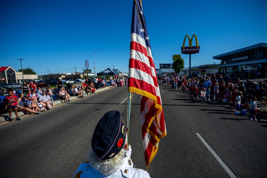 (Trent Nelson  |  The Salt Lake Tribune) Mary Little carries the flag for the American Legion in the Murray City Fun Days Parade on Tuesday, June 30, 2026