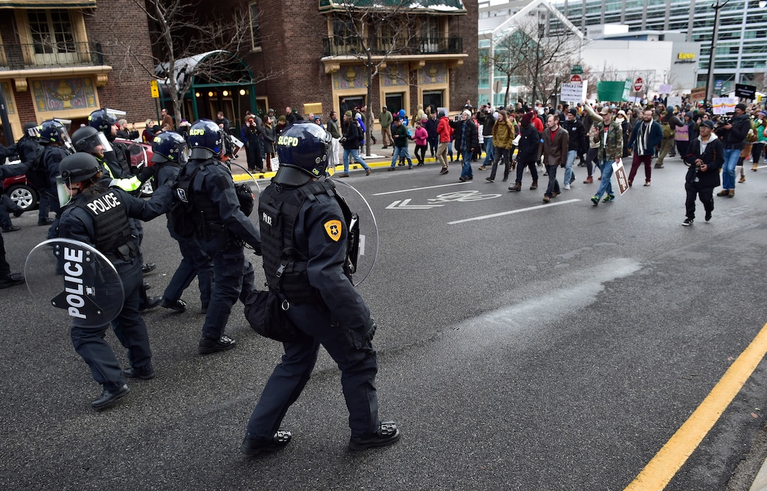 (Scott Sommerdorf   |  The Salt Lake Tribune)   Police retreat away from protestors who had blocked State Street near 100 South after President Trump's visit to Salt Lake City, Monday, December 4, 2017.  