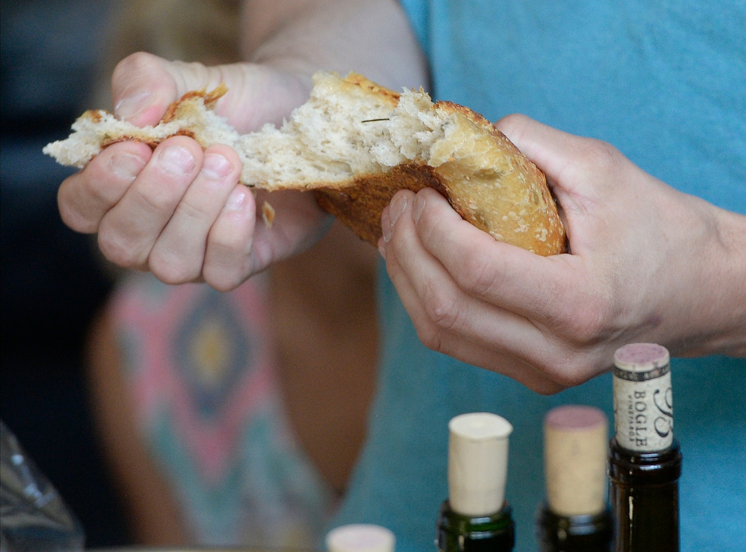 (Al Hartmann  |  The Salt Lake Tribune)
Believers in Denver Snuffer's Remnant movement meet in a Sandy home Sunday, Aug. 13, to sing songs and take sacrament.  After a blessing, the sacrament bread is broken into large pieces and fruit juice or wine is passed around and taken