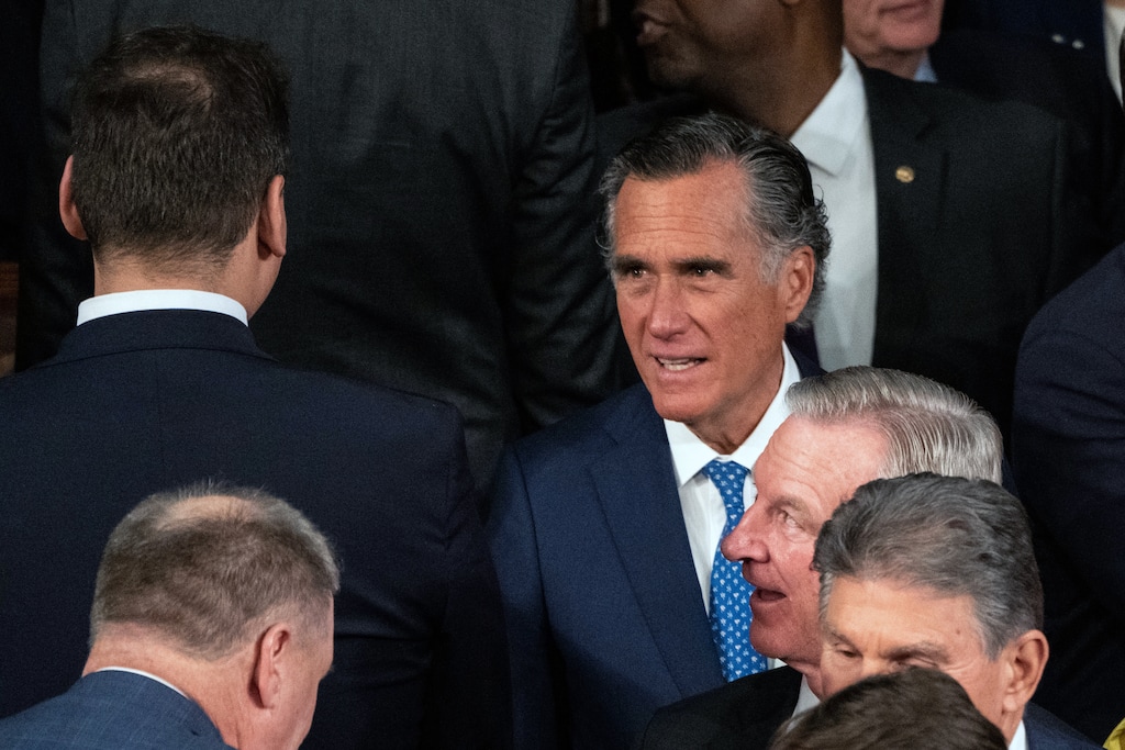 (Haiyun Jiang | The New York Times) Sen. Mitt Romney, R-Utah, right, exchanges words with Rep. George Santos, R-N.Y., a fellow Republican who represents a New York district in Long Island and Queens, before the State of the Union address in Washington on Tuesday night, Feb. 7, 2023. Romney admonished Santos for positioning himself in a prime camera-ready spot in the chamber, saying he didn't belong there, and had no shame.