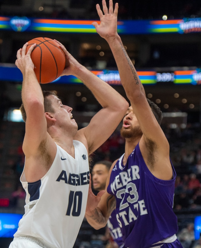 (Rick Egan  |  The Salt Lake Tribune)      Utah State Aggies forward Quinn Taylor (10) looks for a shot, as Weber State Wildcats forward Brekkott Chapman (23) defends, in the Beehive Classic, between against the Utah State Aggies and Weber State Wildcats, a the Vivint Smart Home Arena, Saturday December 8, 2018.

 