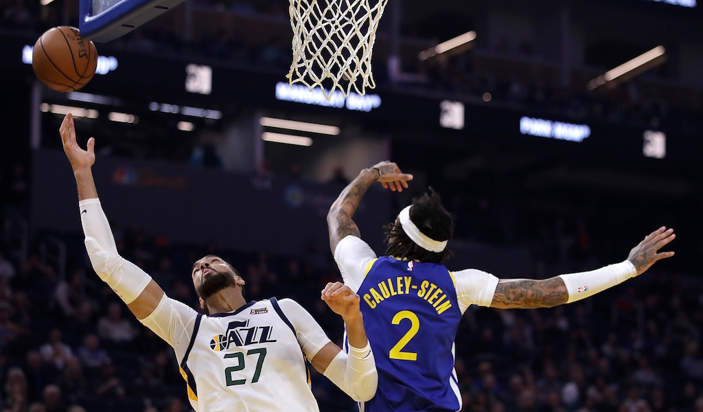 Utah Jazz center Rudy Gobert, left, reaches for a rebound past Golden State Warriors' Willie Cauley-Stein (2) in the first half of an NBA basketball game Wednesday, Jan. 22, 2020, in San Francisco. (AP Photo/Ben Margot)
