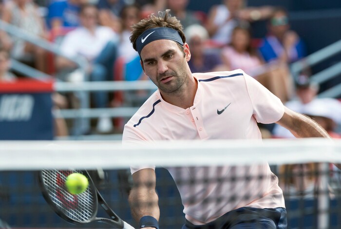 Roger Federer, of Switzerland, goes to the net to return to Roberto Bautista Agut, of Spain, during quarterfinal play at the Rogers Cup tennis tournament, Friday Aug. 11, 2017, in Montreal. (Paul Chiasson/The Canadian Press via AP)