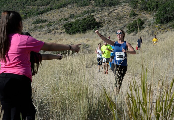 (Scott Sommerdorf | The Salt Lake Tribune) Runners race toward the finish line near the Soldier Hollow train station as they compete against the Heber Creeper train in a 12k race. The race started at the Deer Creek Dam, Saturday, August 19, 2017.