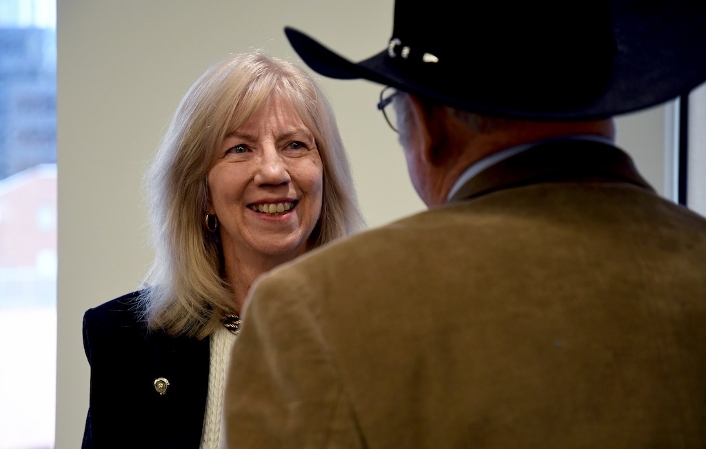 Former Interior Secretary Gale Norton mingles after a news conference in Denver on Monday, Feb. 10, 2020, a day before the Trump administration hosts the first of two hearings on a proposal to roll back a landmark environmental law. Norton says the National Environmental Policy Act, signed by President Richard Nixon in 1970, needs to be modernized to make the permitting process for infrastructure projects quicker. Along with the Clean Air Act and the Clean Water Act, NEPA spells out the nation's principal environmental protections. (AP Photo/Thomas Peipert)