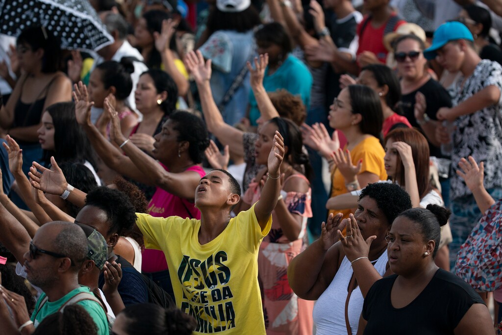 (Leo Correa | AP) Christians raise their hands in praise in Rio de Janeiro, Brazil, in 2020. Tribune columnist argues the people need to remember when they thank God for all their blessings, that not everyone is similar blessed.