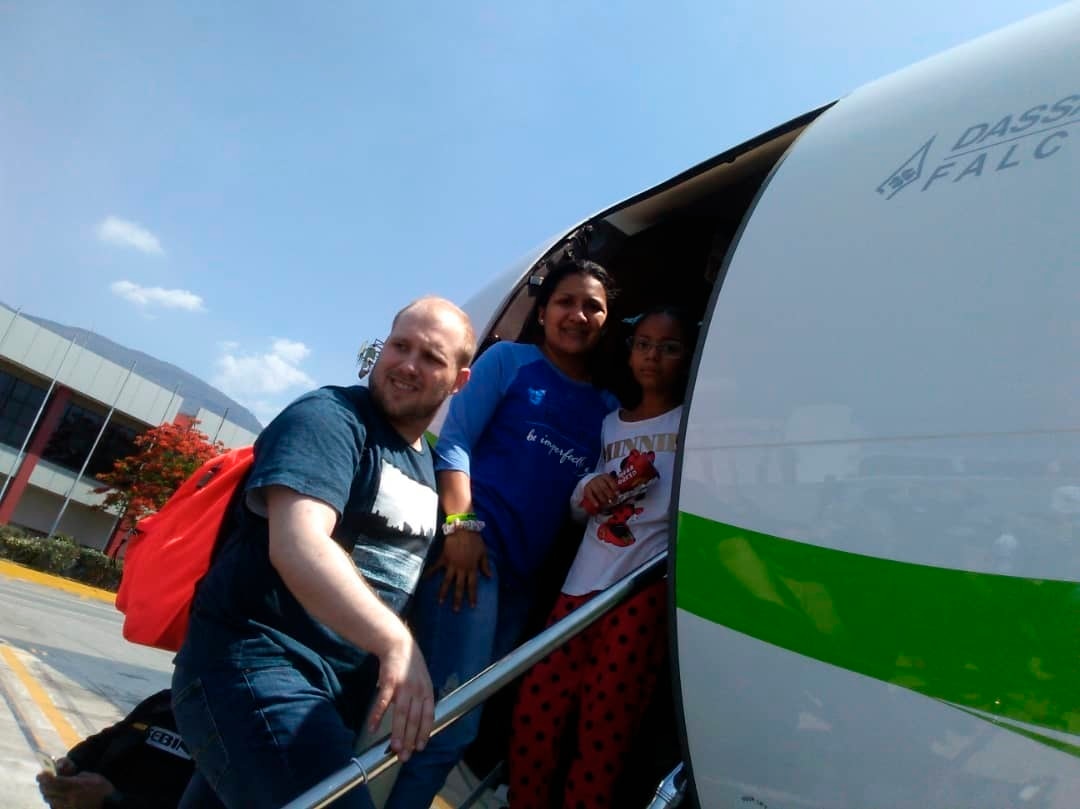 (Holt family photo via AP) In this image provided by the Holt family, Joshua Holt, his wife, Thamara, and her daughter, board a plane at the airport in Caracas, Venezuela, on Saturday, May 26, 2018.  Jailed in Venezuela on weapons charges nearly two years ago, Holt was released Saturday after a U.S. senator pressed for his freedom in a surprise meeting with President Nicolas Maduro. Holt and his wife, who also jailed, were reunited with her daughter from a previous relationship at Caracas’ airport where the three boarded a chartered flight to Washington.