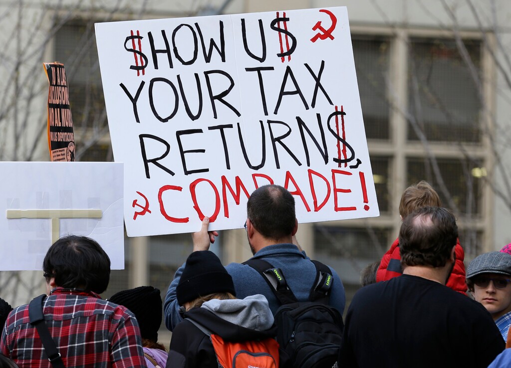 A woman in Seattle holds a sign during a rally that reads "Show us your tax returns, Comrade" in reference to calls for President Donald Trump to release his tax returns and a reference to his alleged ties to Russia, Saturday, April 15, 2017. Trump was the first major-party nominee in more than 40 years not to release his tax returns, saying it was because he was under audit. Similar rallies were held in other U.S. cities as the deadline approaches for 2016 tax returns to be filed. (AP Photo/Ted S. Warren)