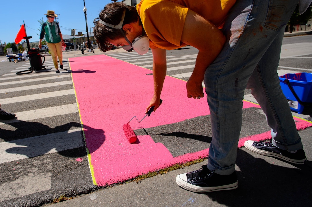 (Trent Nelson  |  The Salt Lake Tribune)  Tyler Bloomquist works on Jann Haworth's Rose art project on Broadway in Salt Lake City on Sunday Aug. 11, 2019. From left, Alex Johnstone, Haworth, and Bloomquist.