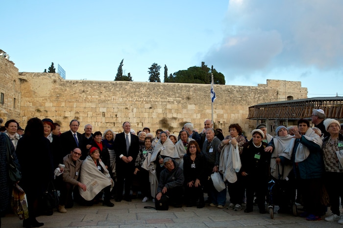 Holocaust survivors pose for a group photo at the Western Wall, the holiest site where Jews can pray in Jerusalem, Thursday, Dec. 14, 2017. (AP Photo/Sebastian Scheiner)