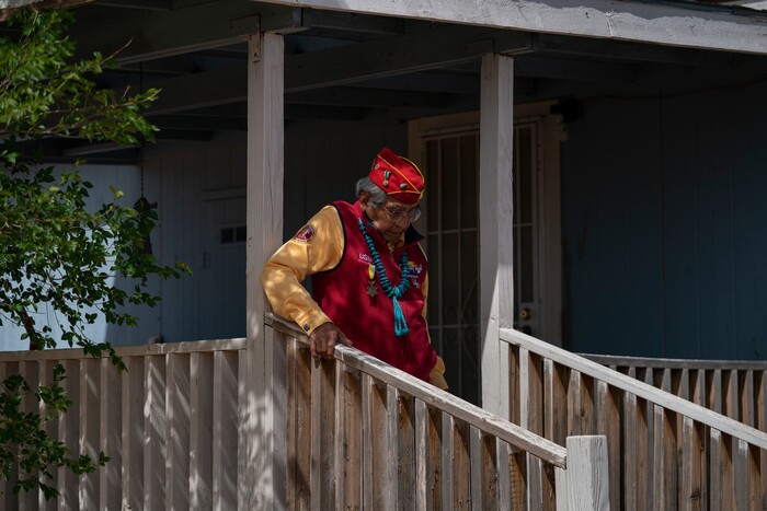 WWII veteran and Navajo Code Talker Peter MacDonald Sr. walks down the porch steps of his home on the Navajo reservation in Tuba City, Ariz., on April 28, 2020. The Navajo reservation has some of the highest rates of coronavirus in the country. If Navajos are susceptible to the virus' spread in part because they are so closely knit, that's also how many believe they will beat it. (AP Photo/Carolyn Kaster)