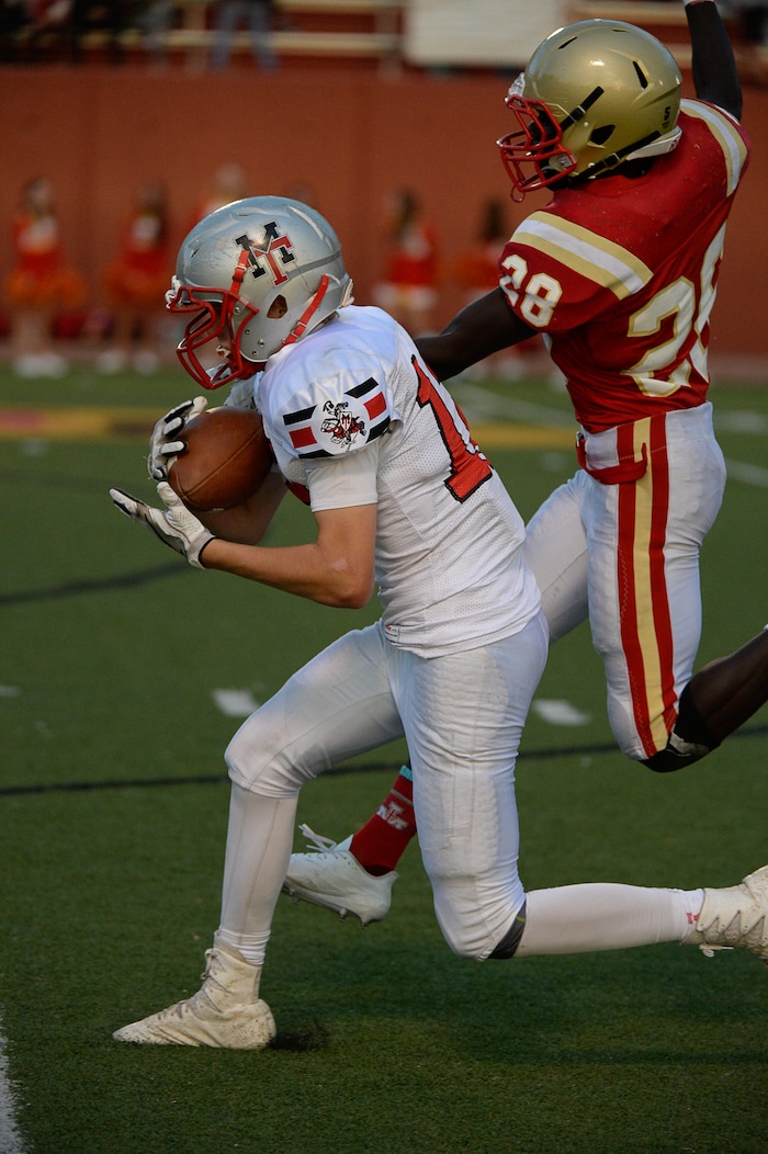 (Francisco Kjolseth  |  The Salt Lake Tribune)  Travis Thompson of Manti pulls in a long pass while pressured by  Fredrick Charles of Judge in the Class 3A football playoff game at Judge Memorial on Thursday, Oct. 19, 2017. 