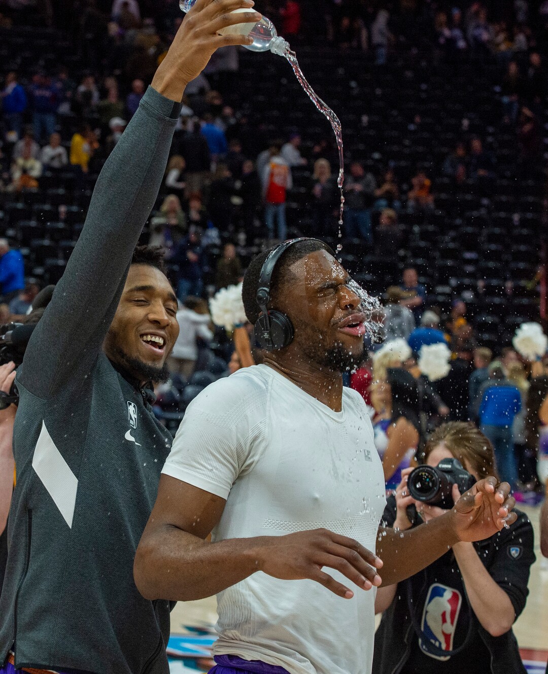 (Rick Egan  |  The Salt Lake Tribune) Utah Jazz guard Donovan Mitchell (45) pours water on Utah Jazz guard Emmanuel Mudiay (8) during a post game interview after the Utah Jazz defeated the New York Knicks 128-104, in NBA action in Salt Lake City, Wednesday, Jan. 8, 2020.