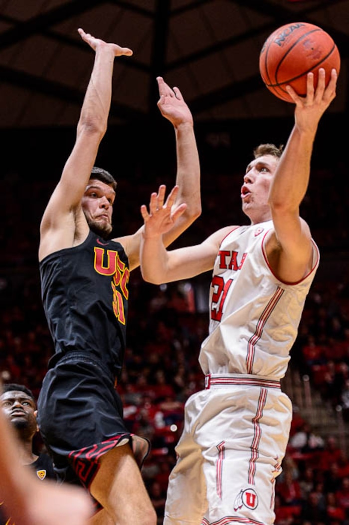 (Trent Nelson | The Salt Lake Tribune)  Utah Utes forward Tyler Rawson (21) shoots with USC Trojans forward Nick Rakocevic (31) defending as the University of Utah hosts USC, NCAA basketball at the Huntsman Center in Salt Lake City, Saturday Feb. 24, 2018.